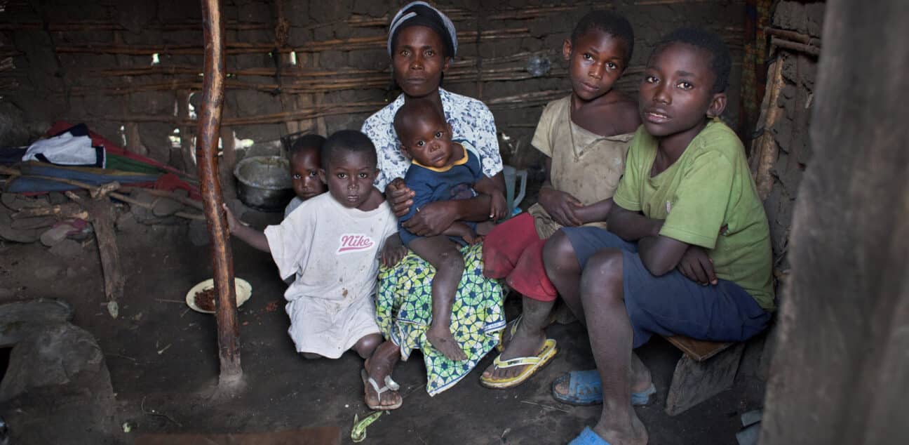 Woman and children sit in a home